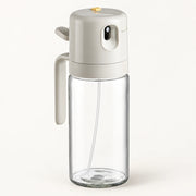 2-in-1 Glass Oil Sprayer and Dispenser on a warm off-white background with a soft natural shadow.