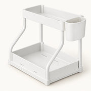2-Tier Pull-Out Cabinet Organizer on a warm off-white background with a soft natural shadow.