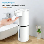 White touchless foaming soap dispenser beside a bathroom sink