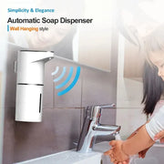 Wall-mounted touchless foaming soap dispenser installed above a bathroom sink