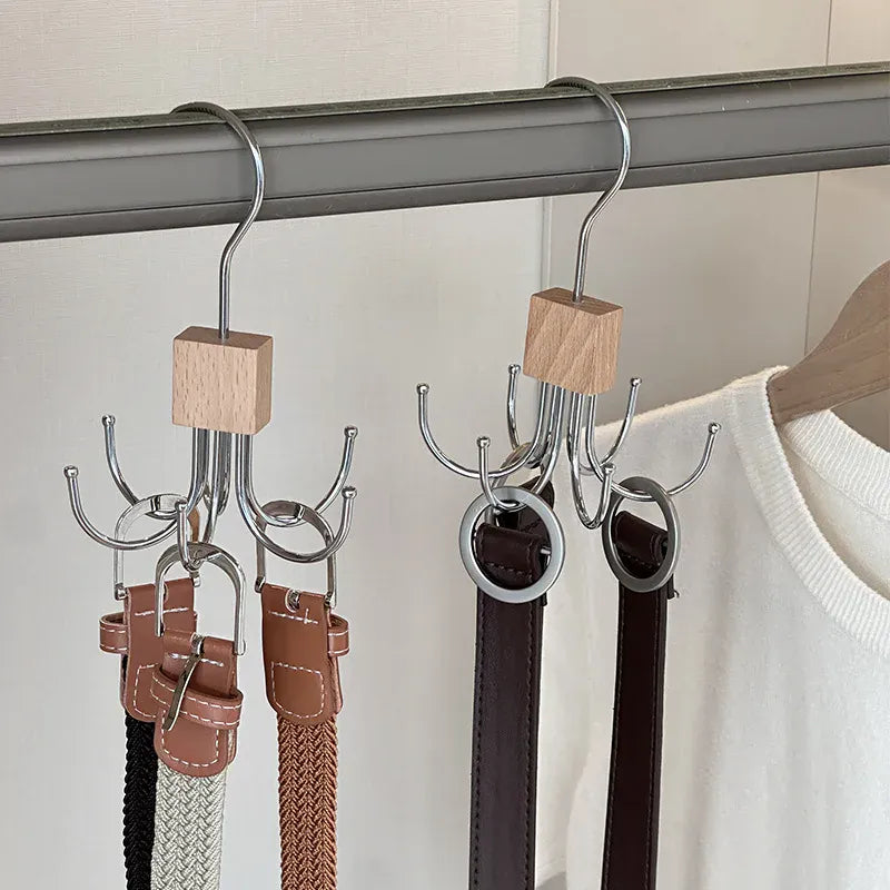 Rotating closet hooks holding belts and accessories on a rail