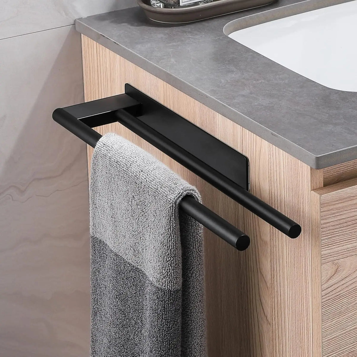 Black towel bar mounted under a bathroom counter