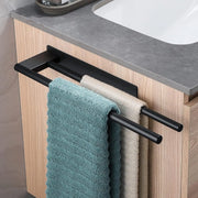 Black adhesive towel bar holding blue and gray towels