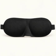 Black contoured sleep mask with molded eye cups and elastic strap ends.