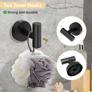 Black double robe hook holding a bath sponge