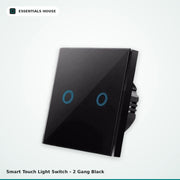A 2-gang black touch-sensitive light switch with a glossy glass faceplate and blue circular touch感应 zones, shown on a light