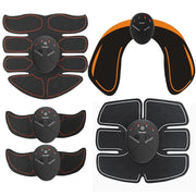 Set of black and orange electronic muscle stimulators on a white background