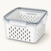 Clear food storage container with a white perforated drain basket and snap-lock lid.