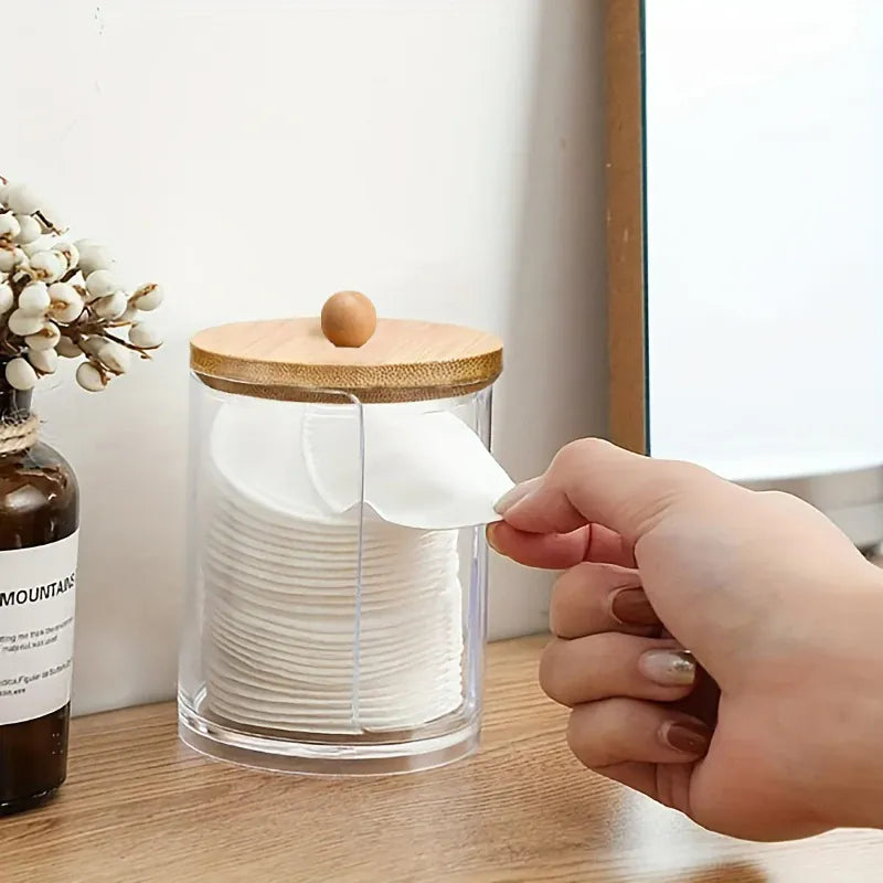 Hand opening a clear jar with bamboo lid and side handle