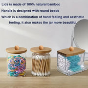 Storage jars holding cotton swabs, flossers, and elastic bands