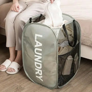 Gray pop-up mesh laundry hamper filled with clothes