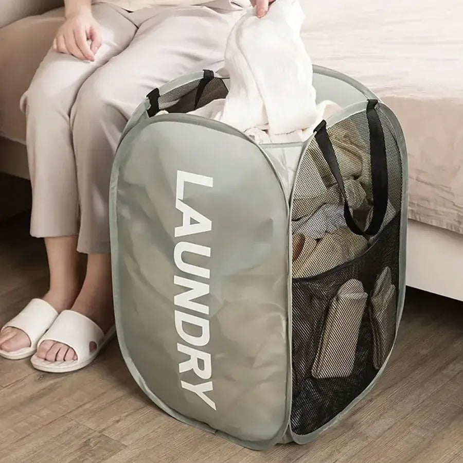 Gray pop-up mesh laundry hamper filled with clothes