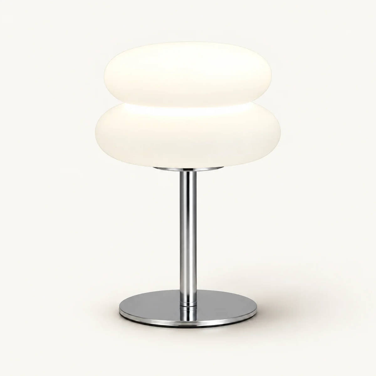 Bedside lamp with two rounded cream shade sections, chrome stem and round chrome base on an off-white background.