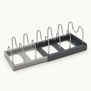 Expandable Pot and Pan Organizer on a warm off-white background with a soft natural shadow.