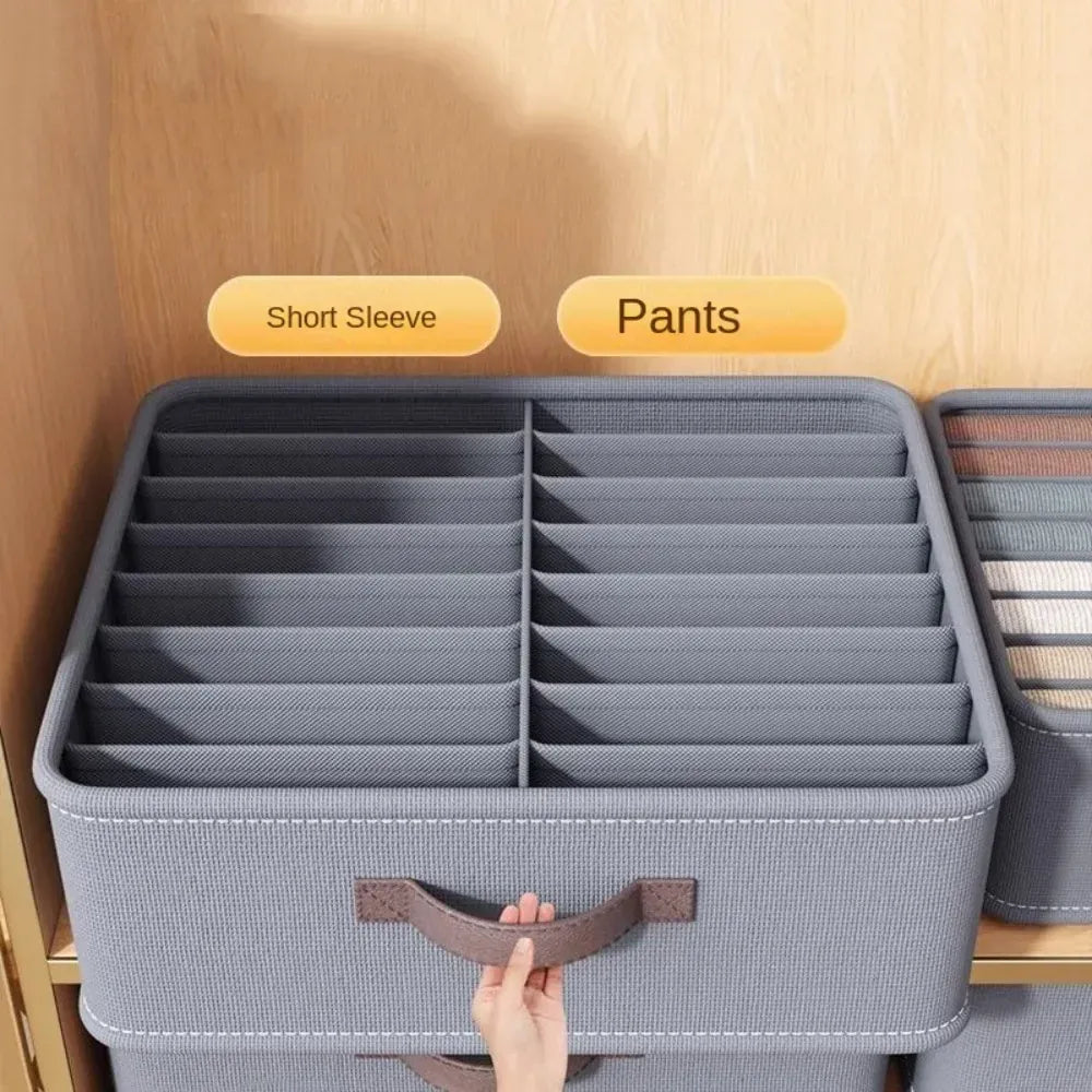 Gray drawer organizer with separate sections for shirts and pants