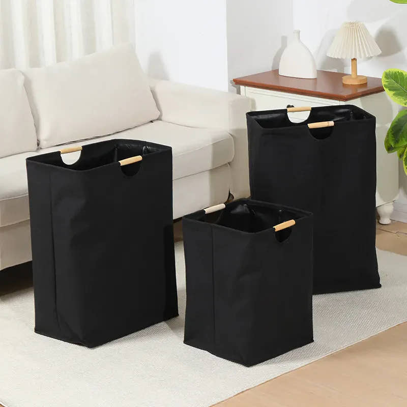 Three black foldable laundry baskets in different sizes