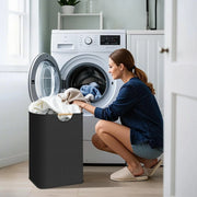 Black laundry basket beside an open washing machine