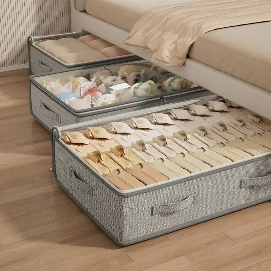 Gray under-bed storage bin holding folded clothes
