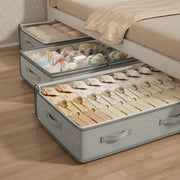 Gray under-bed storage bin holding folded clothes