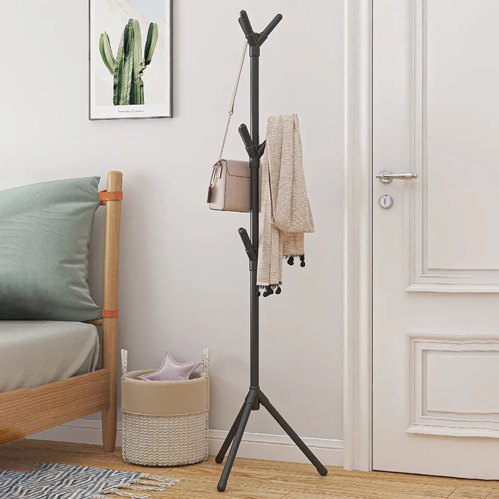Black freestanding coat rack holding bags and clothing