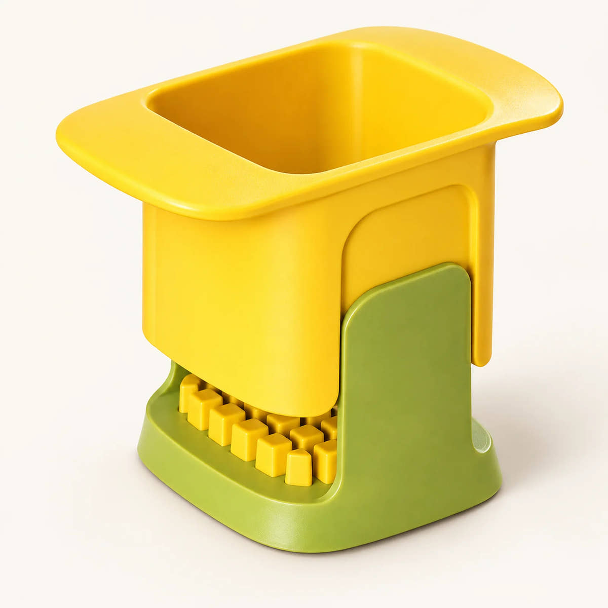 Hand-Press Vegetable Dicer on a warm off-white background with a soft natural shadow.