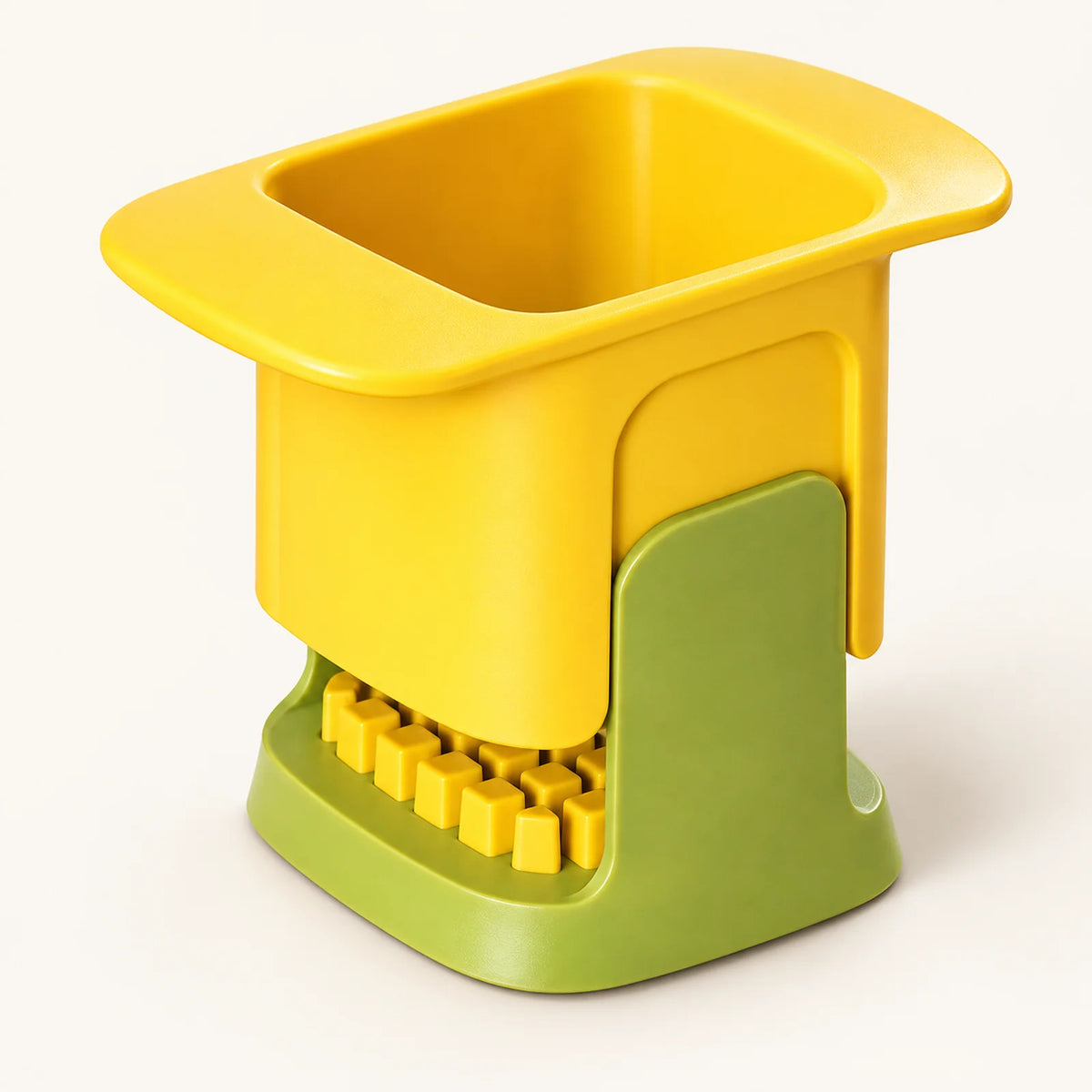 Hand-Press Vegetable Dicer on a warm off-white background with a soft natural shadow.