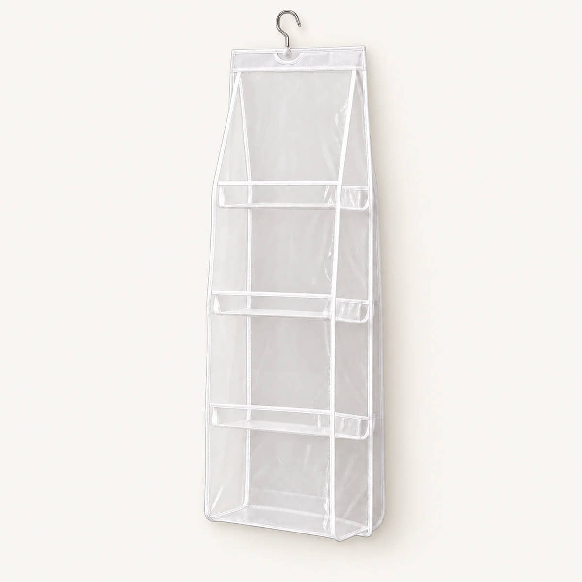 White hanging handbag organizer with four clear compartments