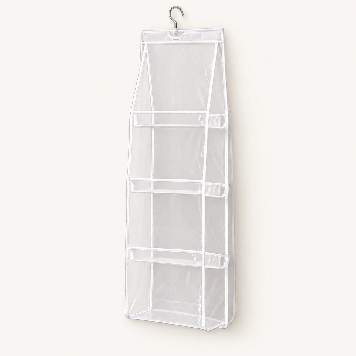 White hanging handbag organizer with four clear compartments
