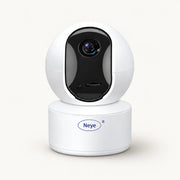 White Neye indoor security camera with black lens panel and cylindrical base on a warm off-white background.
