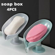 Four leaf-shaped self-draining soap dishes with bar soap