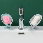 Leaf soap dishes beside bathroom and kitchen faucets