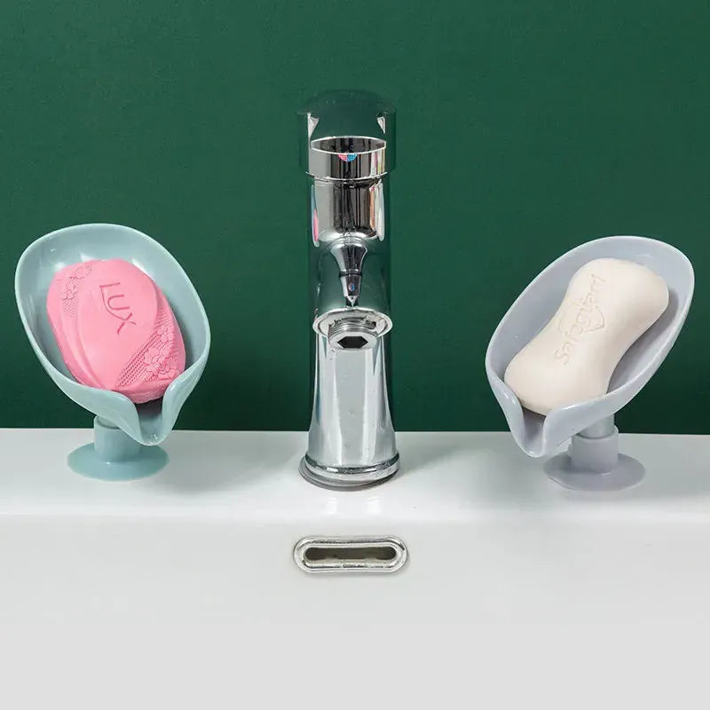 Leaf soap dishes beside bathroom and kitchen faucets
