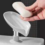 Bar soap resting on a white leaf-shaped draining dish