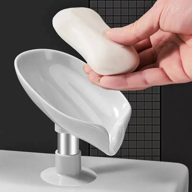 Bar soap resting on a white leaf-shaped draining dish