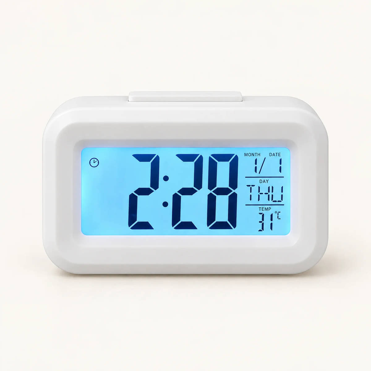 White digital desk alarm clock with blue backlit time, calendar and temperature display.