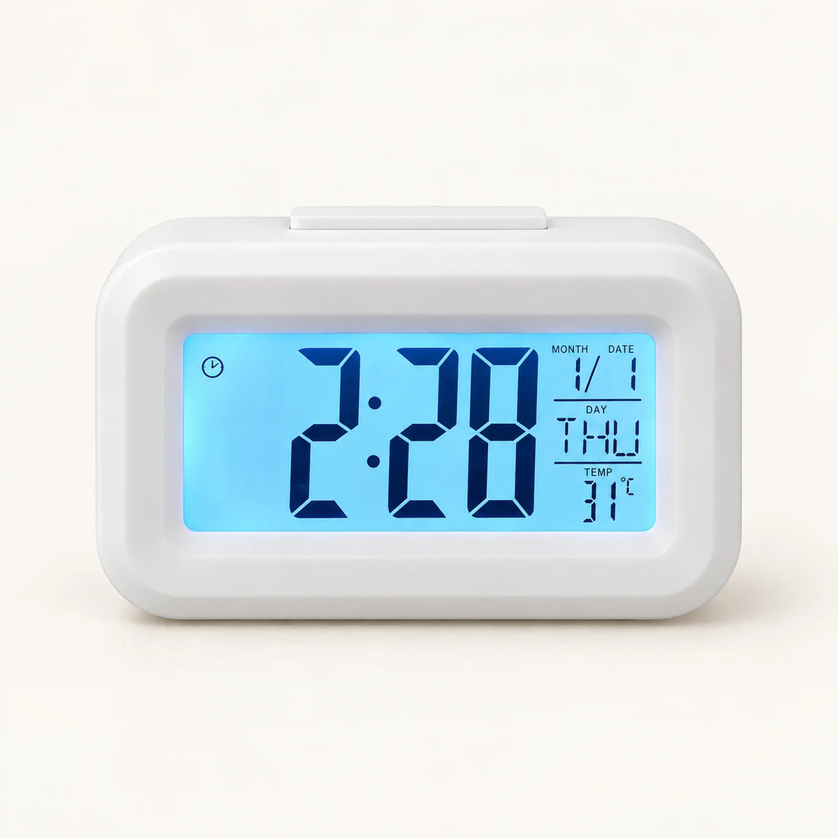 White digital desk alarm clock with blue backlit time, calendar and temperature display.