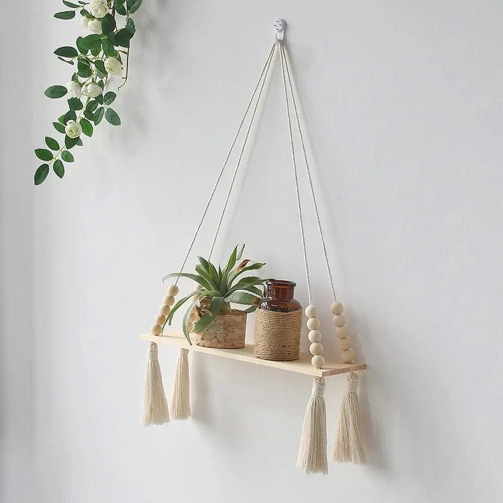 Two-tier macrame wall shelf holding potted plants