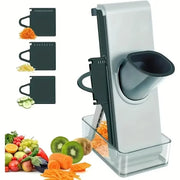 Light grey mandoline slicer with collection container and three blade inserts for slices and julienne strips.