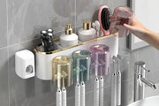 Hand placing a cup on the wall-mounted toothbrush organizer