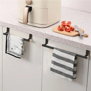 Black over-cabinet towel bars holding kitchen towels