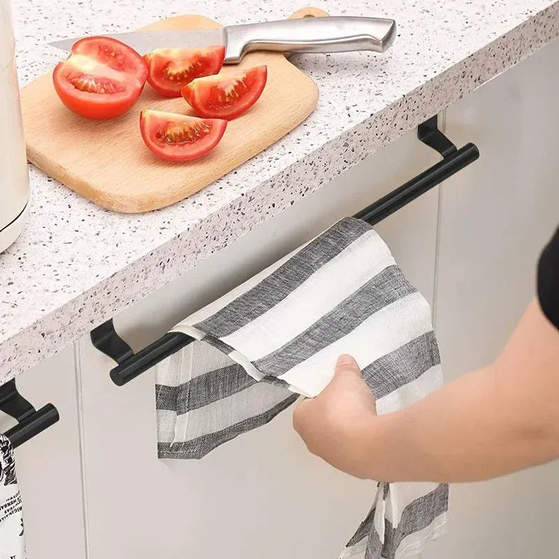 Black over-cabinet towel bar holding a striped towel