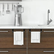 Two white over-cabinet towel bars in a kitchen
