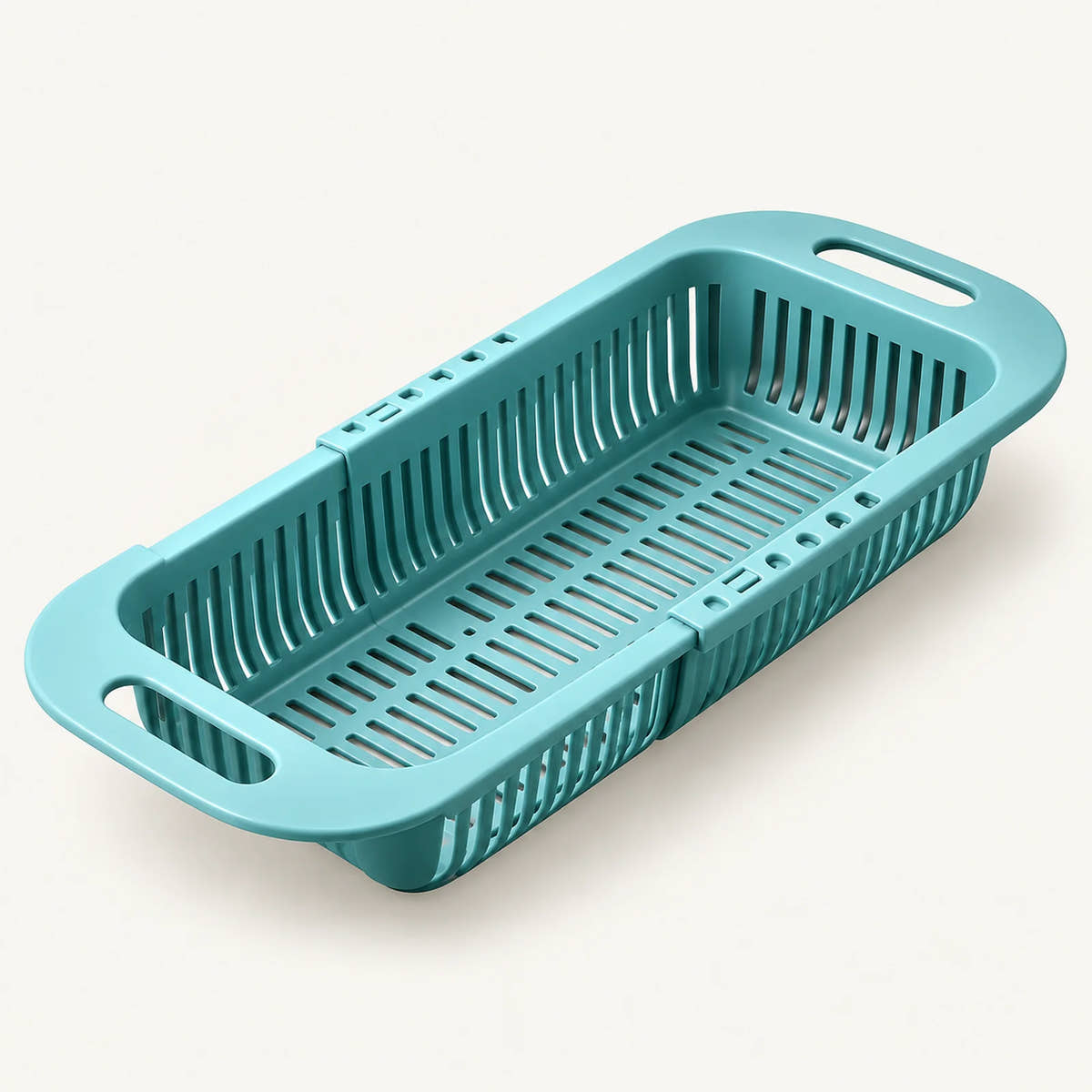 Extendable Over-the-Sink Colander on a warm off-white background with a soft natural shadow.