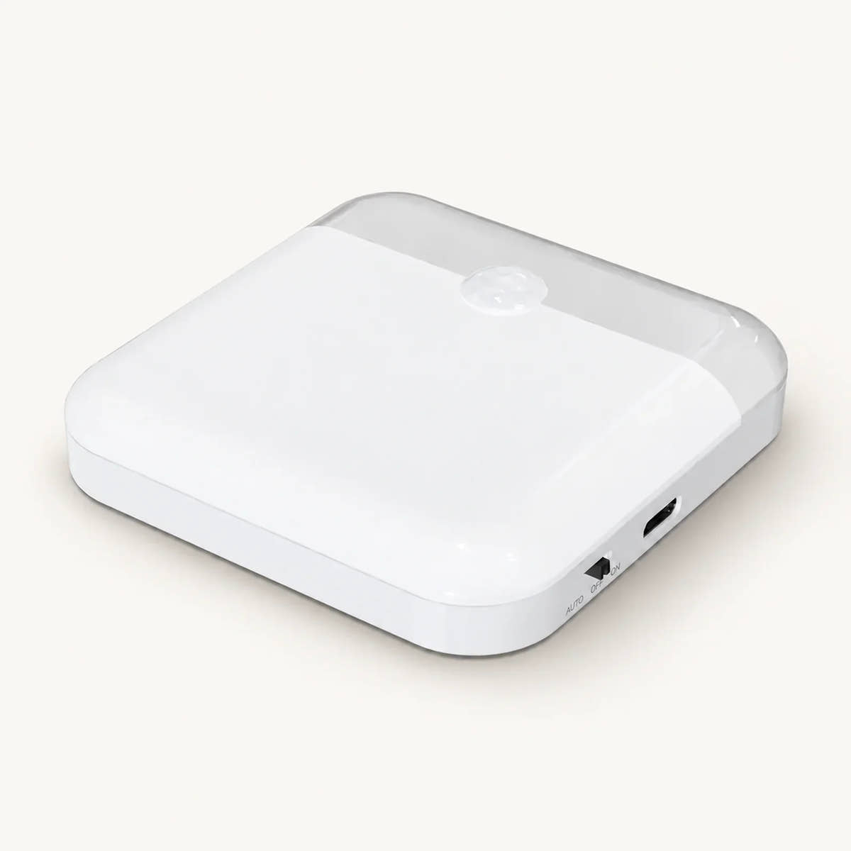 White square motion sensor night light with rounded corners, sensor dome and side controls on an off-white background.