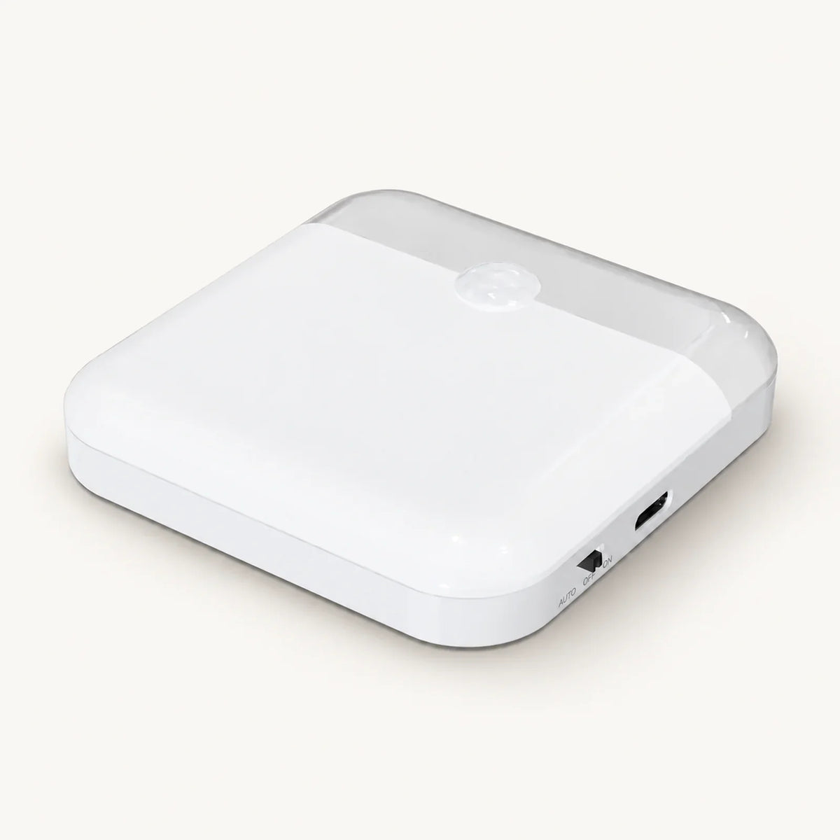 White square motion sensor night light with rounded corners, sensor dome and side controls on an off-white background.