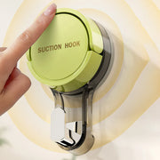 Finger pressing the center of a green suction hook