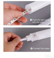 Two assembly steps showing hands pushing the LED strip into the lamp tube and connecting the tube sections.