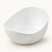 Rice Rinsing and Drainage Basket on a warm off-white background with a soft natural shadow.