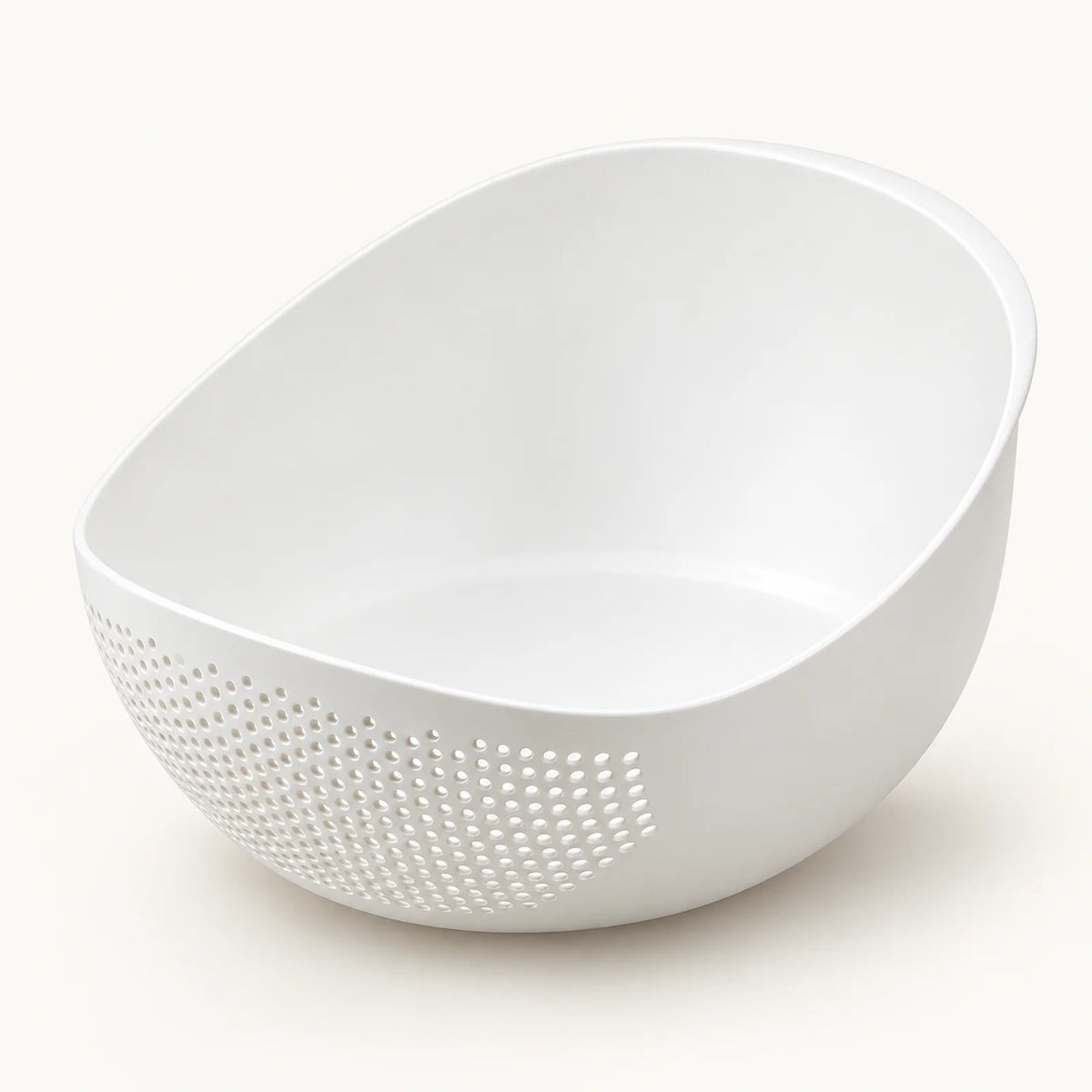 Rice Rinsing and Drainage Basket on a warm off-white background with a soft natural shadow.