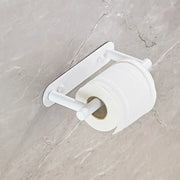 White rotating toilet paper holder mounted on marble tile
